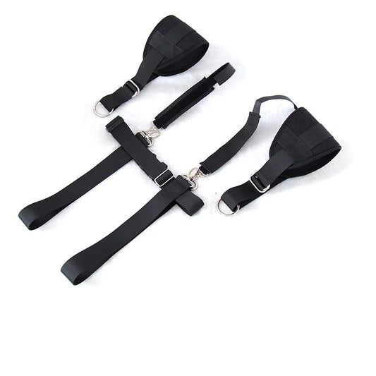 Adjustable black body restraint harness kit with wrist and thigh cuffs connected by durable nylon straps.