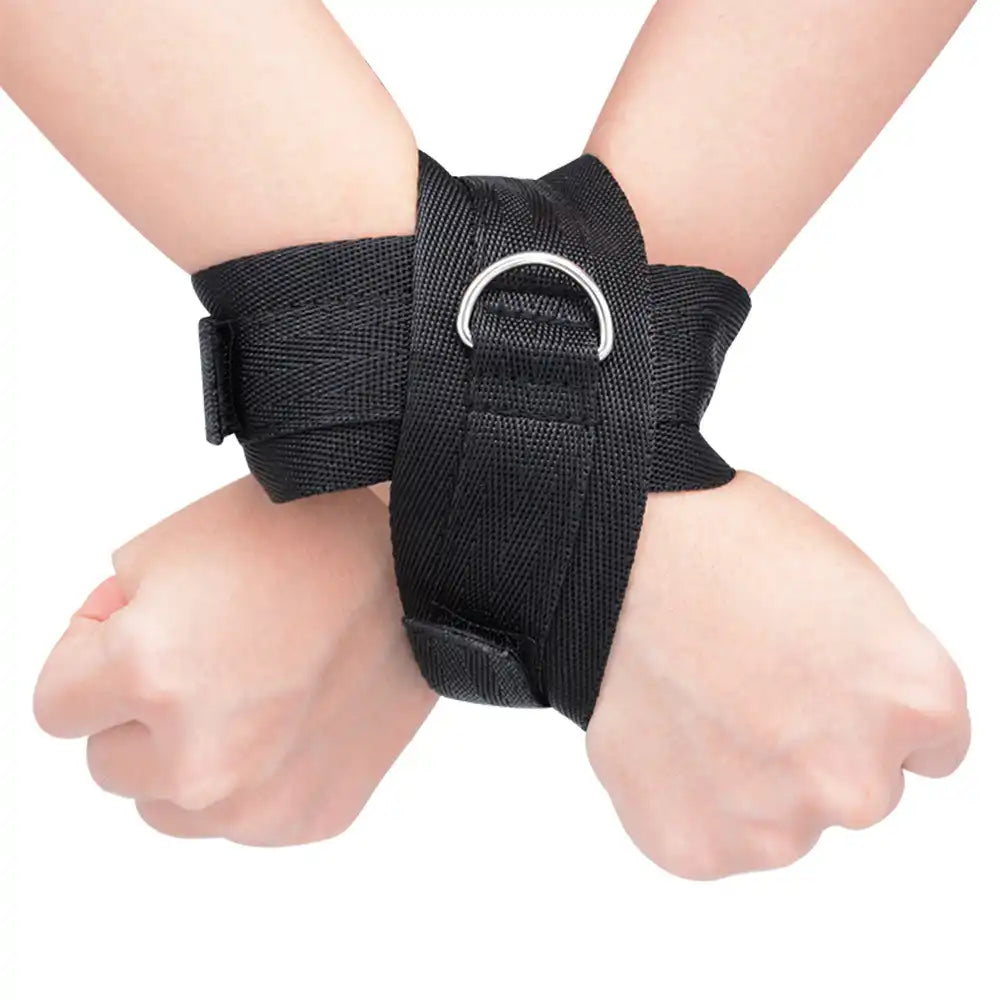 Adjustable double wrist restraint cuffs connected with a metal D-ring and soft padded lining