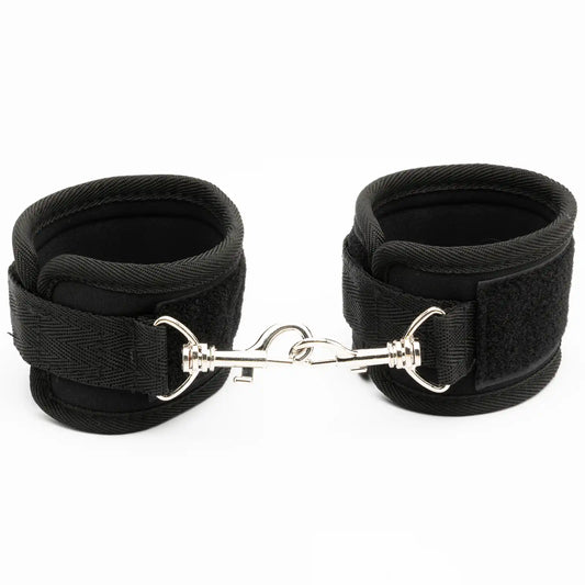 Pair of adjustable padded wrist restraint cuffs connected with a metal lock connector.