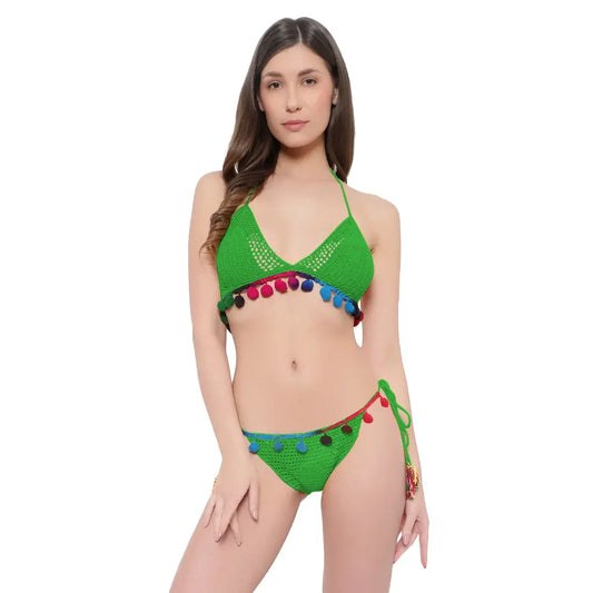 Handmade crochet bikini set with pom-pom detailing and tie side beachwear styling.