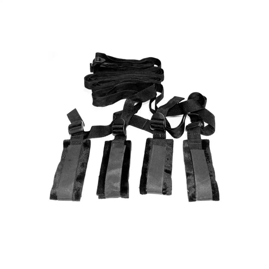 Full bed restraint system with adjustable wrist cuffs, ankle cuffs, and connecting straps.