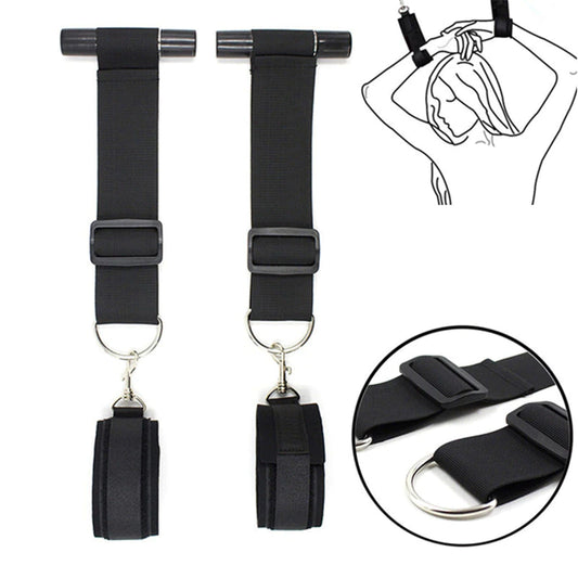 Black over-the-door restraint kit with adjustable straps and padded wrist cuffs attached to a door anchor system.