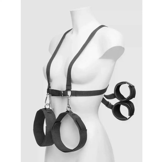 Black upper body harness with adjustable wrist cuffs, leg restraints, and connecting nylon straps.