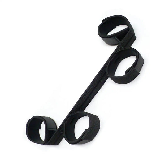 Black wrist-to-ankle restraint set with adjustable padded wrist and ankle cuffs connected by durable nylon straps.