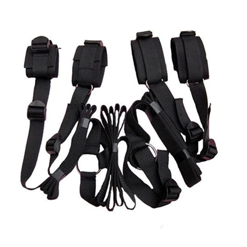 Black adjustable bed restraint kit with under-mattress anchor system and four padded restraint cuffs.
