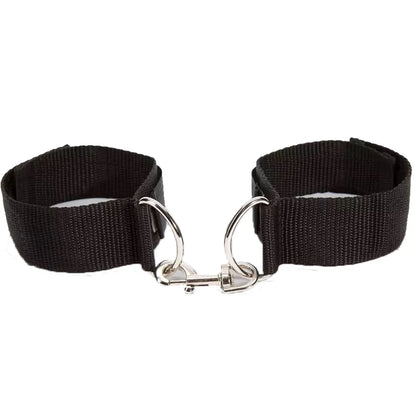 Adjustable black ankle cuffs with soft padding and metal lock connector between the cuffs.