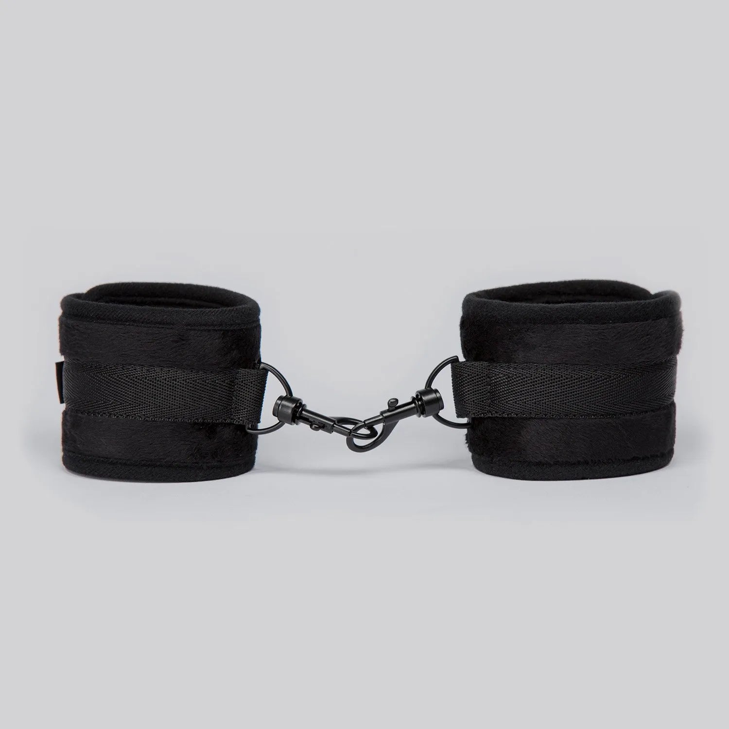 Adjustable black ankle cuffs with soft padding and metal lock connector between the cuffs.
