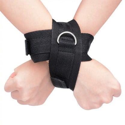 Adjustable double wrist restraint cuffs connected with a metal D-ring and soft padded lining