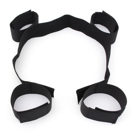 Adjustable black spreader bar restraint kit with wrist cuffs and ankle cuffs connected by secure straps.