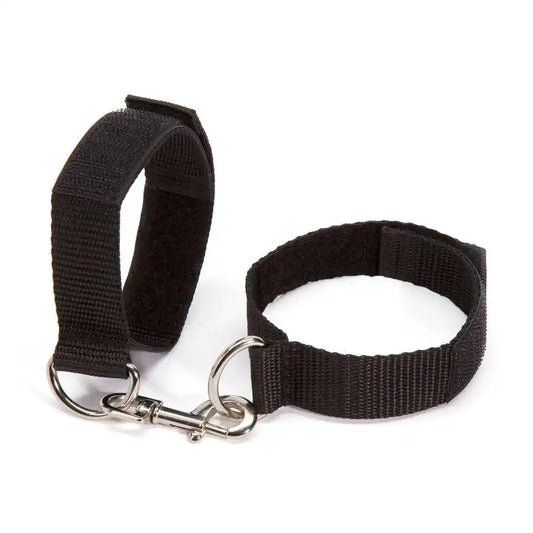 Adjustable wrist handcuff pair with metal lock connector and nylon straps.