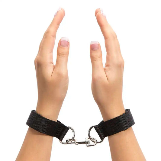 Adjustable wrist handcuff pair with metal lock connector and nylon straps.
