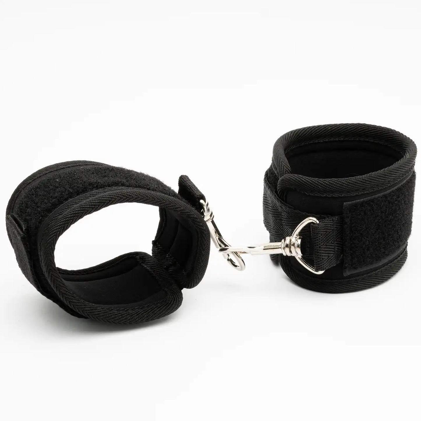 Pair of adjustable padded wrist restraint cuffs connected with a metal lock connector.

