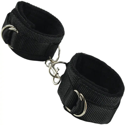 Pair of adjustable padded wrist restraint cuffs connected with a metal lock connector.
