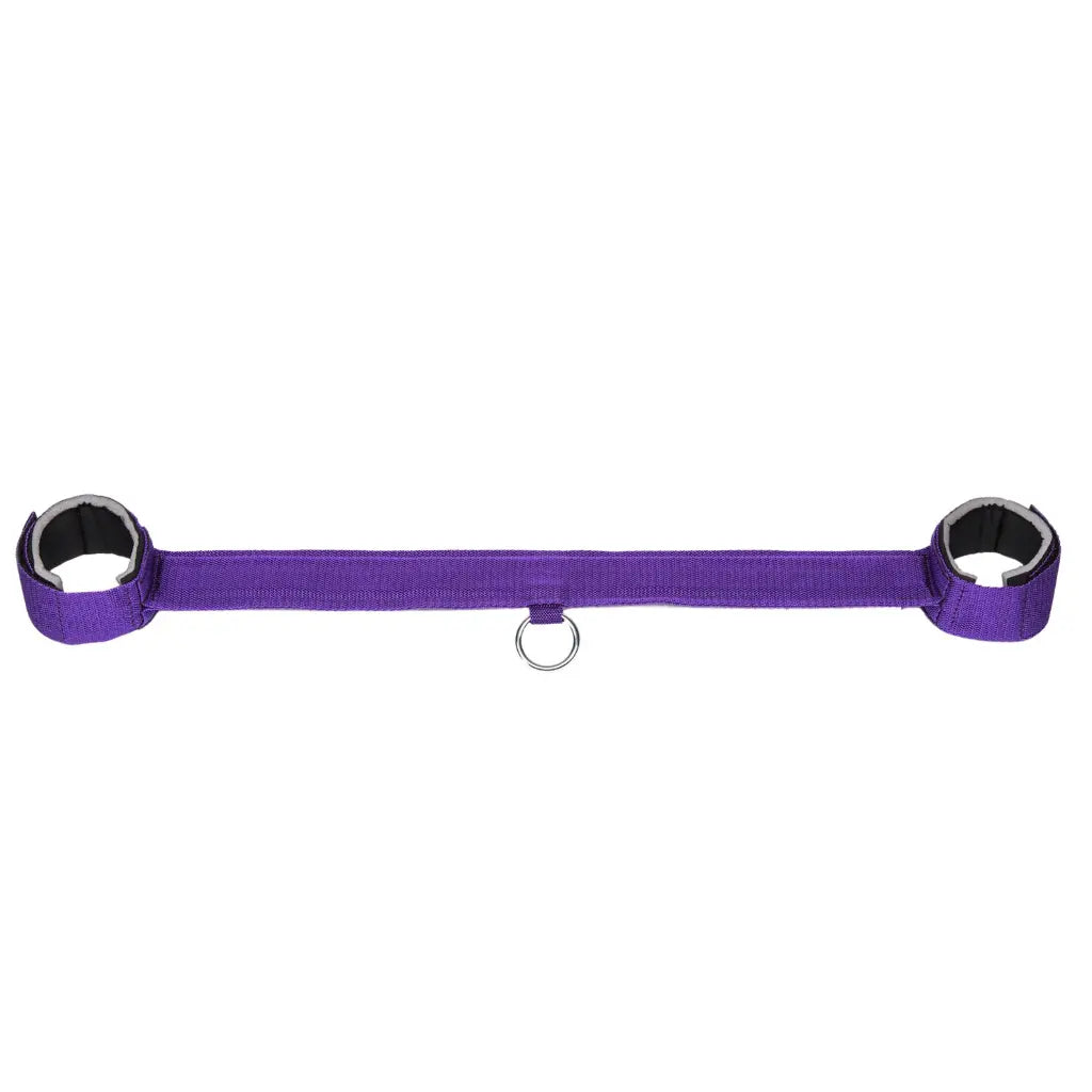 Purple wrist and ankle restraint set with adjustable straps and central metal ring.
