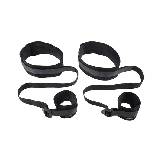 Adjustable black wrist and thigh restraint set with padded cuffs and connecting straps.