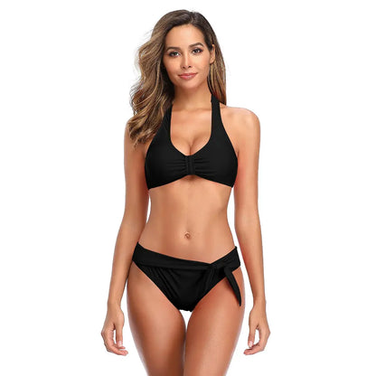woman wearing chic black halter neck bikini set with high waist tie side bottom for stylish beachwear fashion