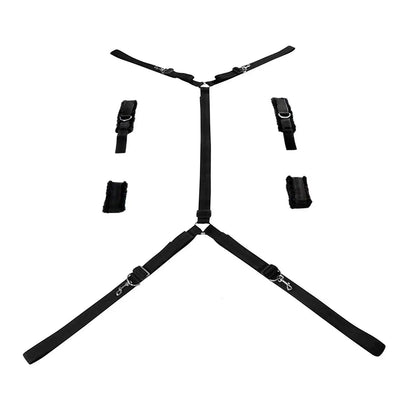 Full bed restraint system with adjustable wrist cuffs, ankle cuffs, and connecting straps.