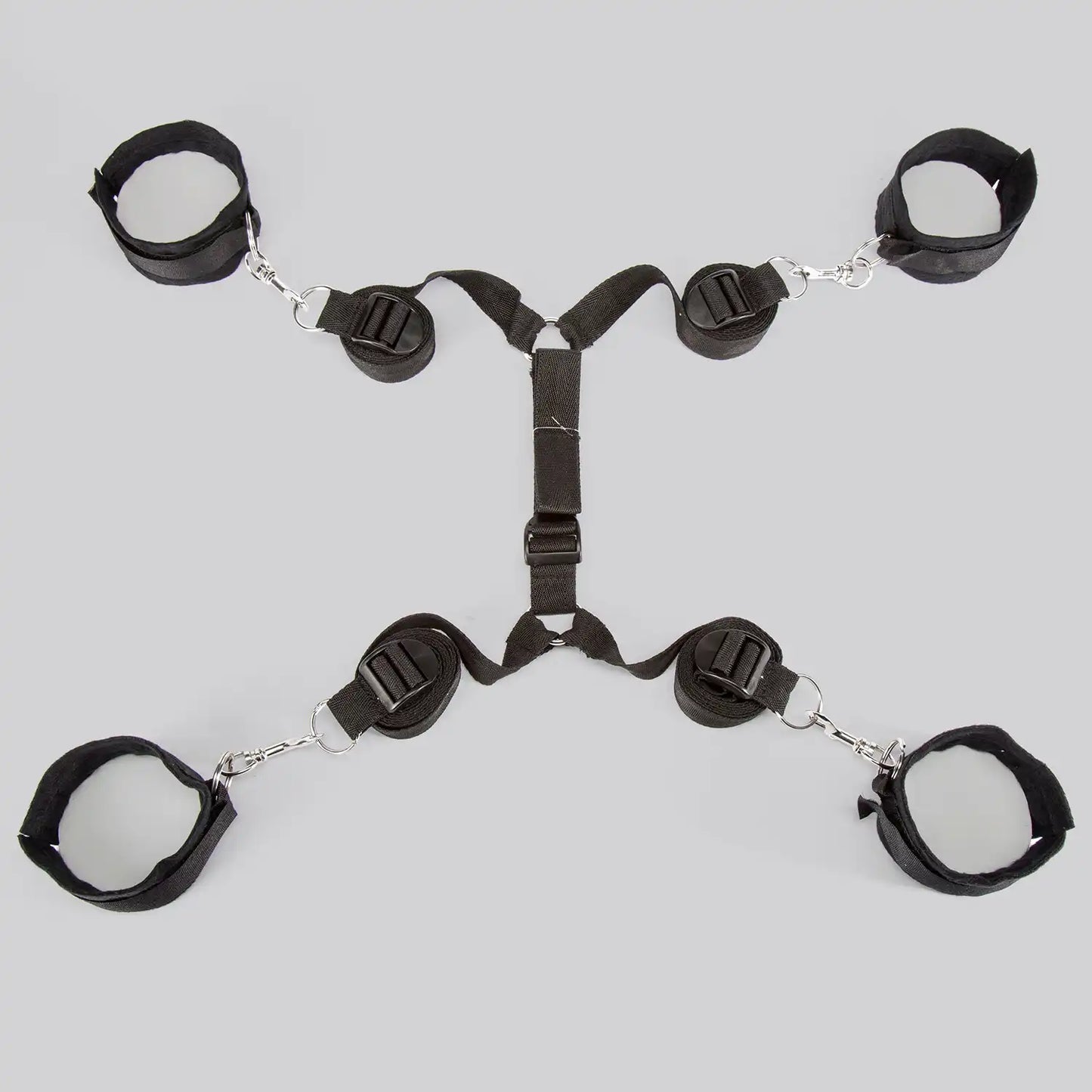 Full bed restraint system with adjustable wrist cuffs, ankle cuffs, and connecting straps.