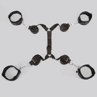 Full bed restraint system with adjustable wrist cuffs, ankle cuffs, and connecting straps.