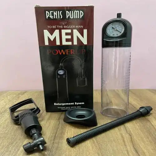 Men's manual vacuum pump system with transparent measurement cylinder and ergonomic hand pump.
