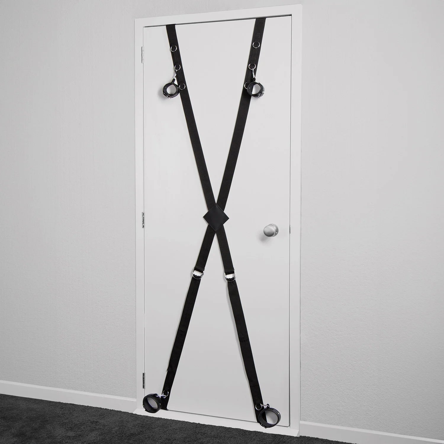 Over-the-door full restraint kit with adjustable wrist and ankle cuffs attached to a door-mounted strap system.
