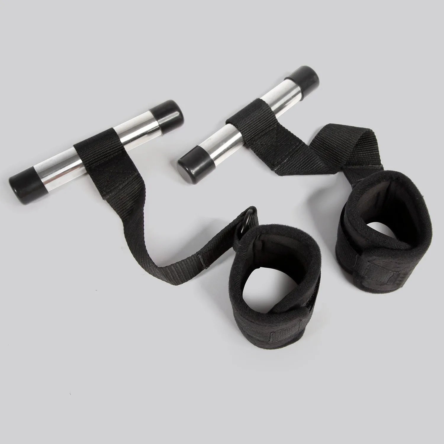 Black over-the-door restraint kit with adjustable straps and padded wrist cuffs attached to a door anchor system.