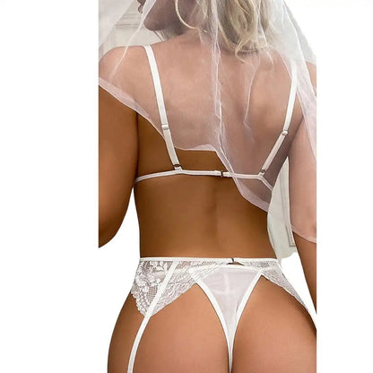 Professional studio shot of a multi-piece bridal themed sleepwear set featuring a white lace bralette, garter belt, strappy panty, and sheer white veil.