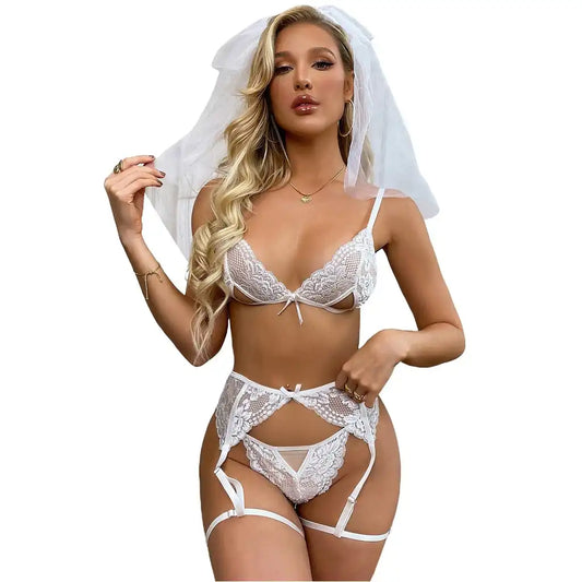Professional studio shot of a multi-piece bridal themed sleepwear set featuring a white lace bralette, garter belt, strappy panty, and sheer white veil.