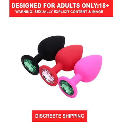 Red silicone butt plug with sparkling crystal gem base and smooth body-safe finish.