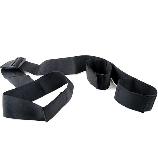 Black collar connected to an adjustable wrist restraint cuff with a nylon strap.
