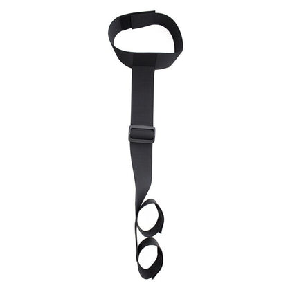 Black collar connected to an adjustable wrist restraint cuff with a nylon strap.