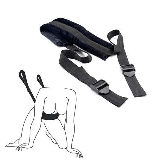 Soft material bondage positioning strap with padded support sections and adjustable straps.