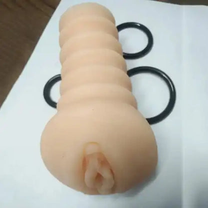 Soft silicone ribbed massager sleeve for men with adjustable pressure rings and reusable design.