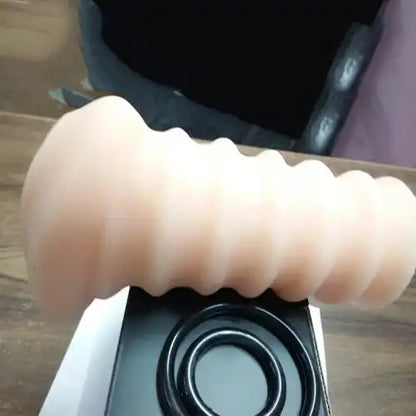 Soft silicone ribbed massager sleeve for men with adjustable pressure rings and reusable design.