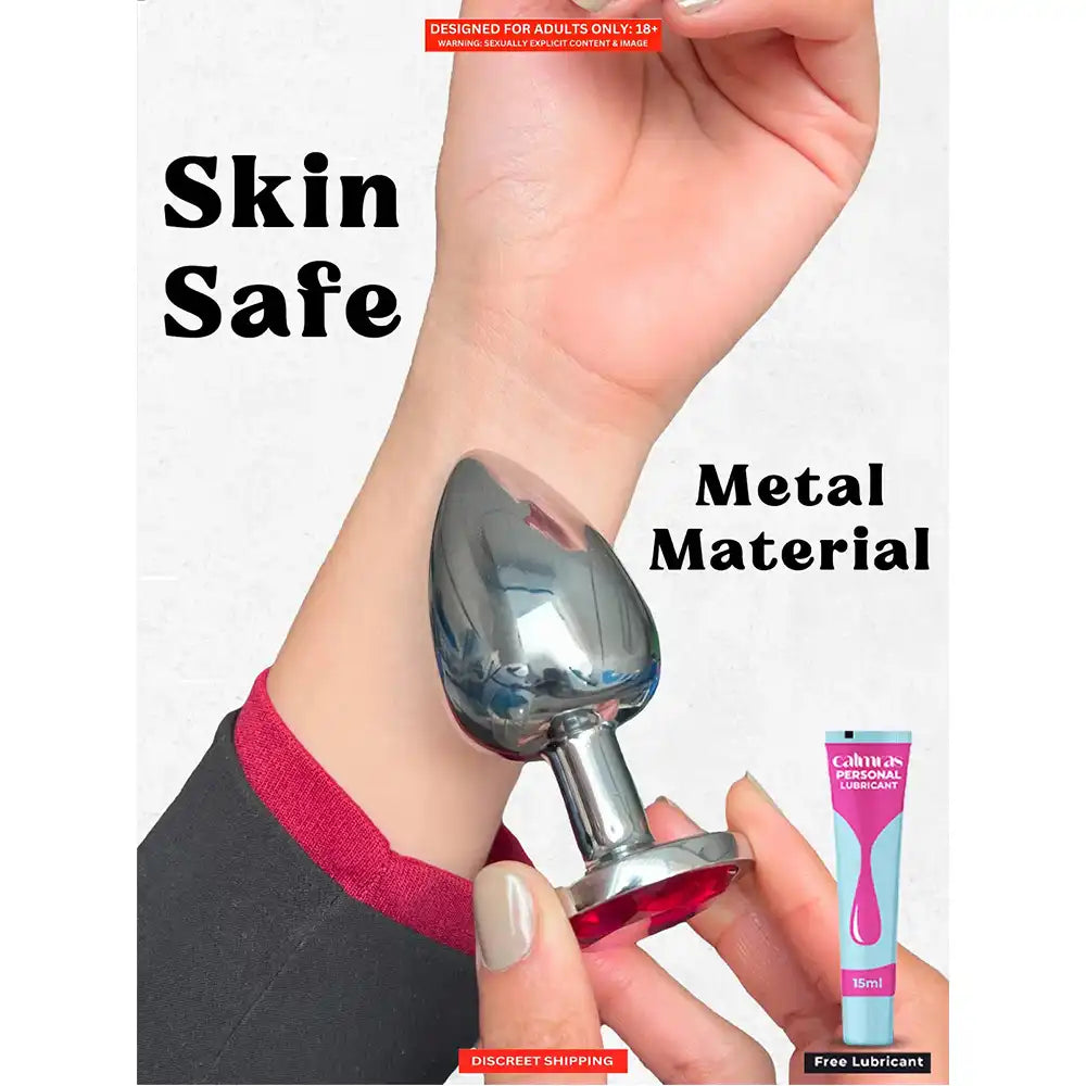 Stainless steel butt plug with mirror-polished finish and pink crystal gem base.