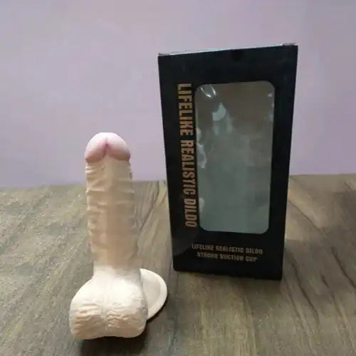 Realistic silicone massager for women with suction base and flexible body-safe silicone construction.