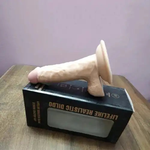 Realistic silicone massager for women with suction base and flexible body-safe silicone construction.