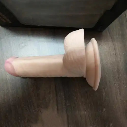 Realistic silicone massager for women with suction base and flexible body-safe silicone construction.