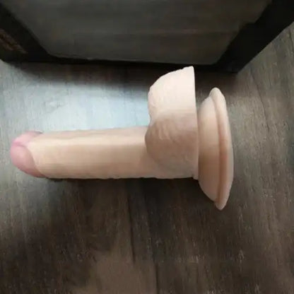 Realistic silicone massager for women with suction base and flexible body-safe silicone construction.