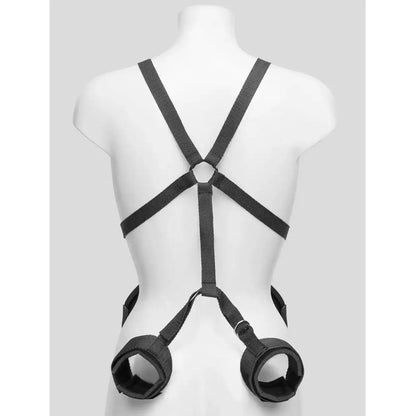 Black upper body harness with adjustable wrist cuffs, leg restraints, and connecting nylon straps.
