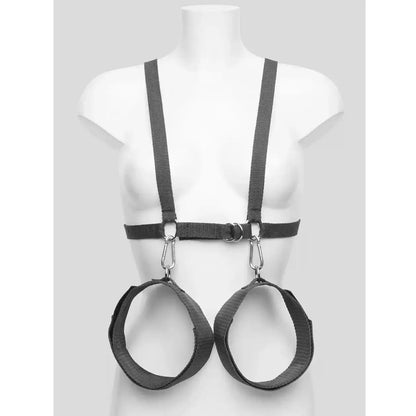 Black upper body harness with adjustable wrist cuffs, leg restraints, and connecting nylon straps.
