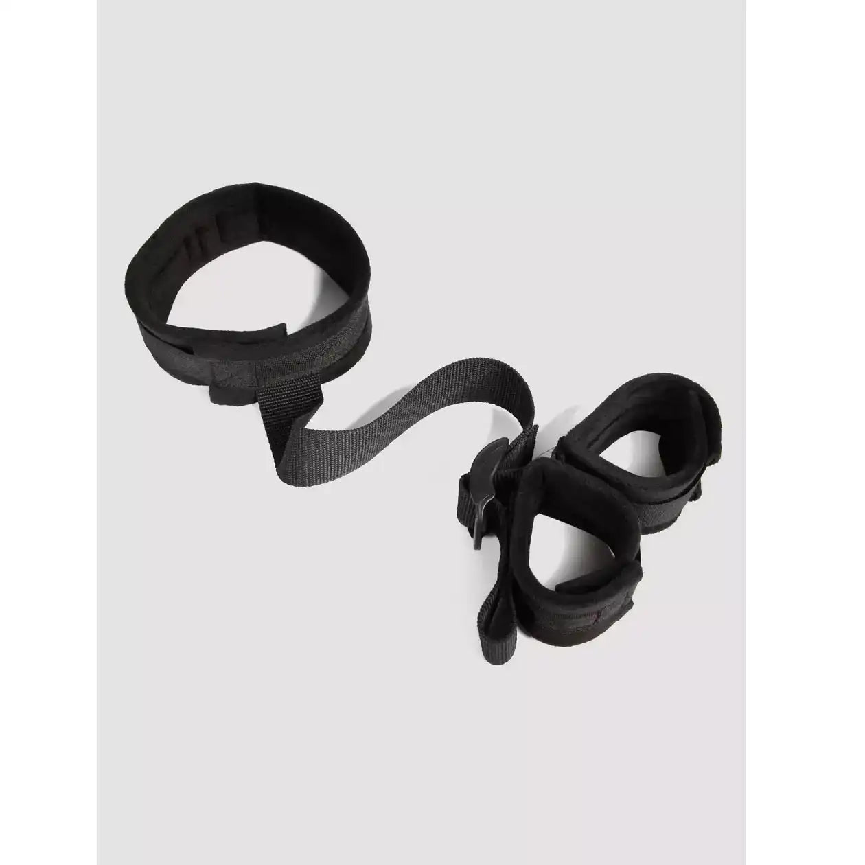 Black wrist-to-collar restraint set with padded wrist cuffs, adjustable neck collar, and connecting nylon strap.