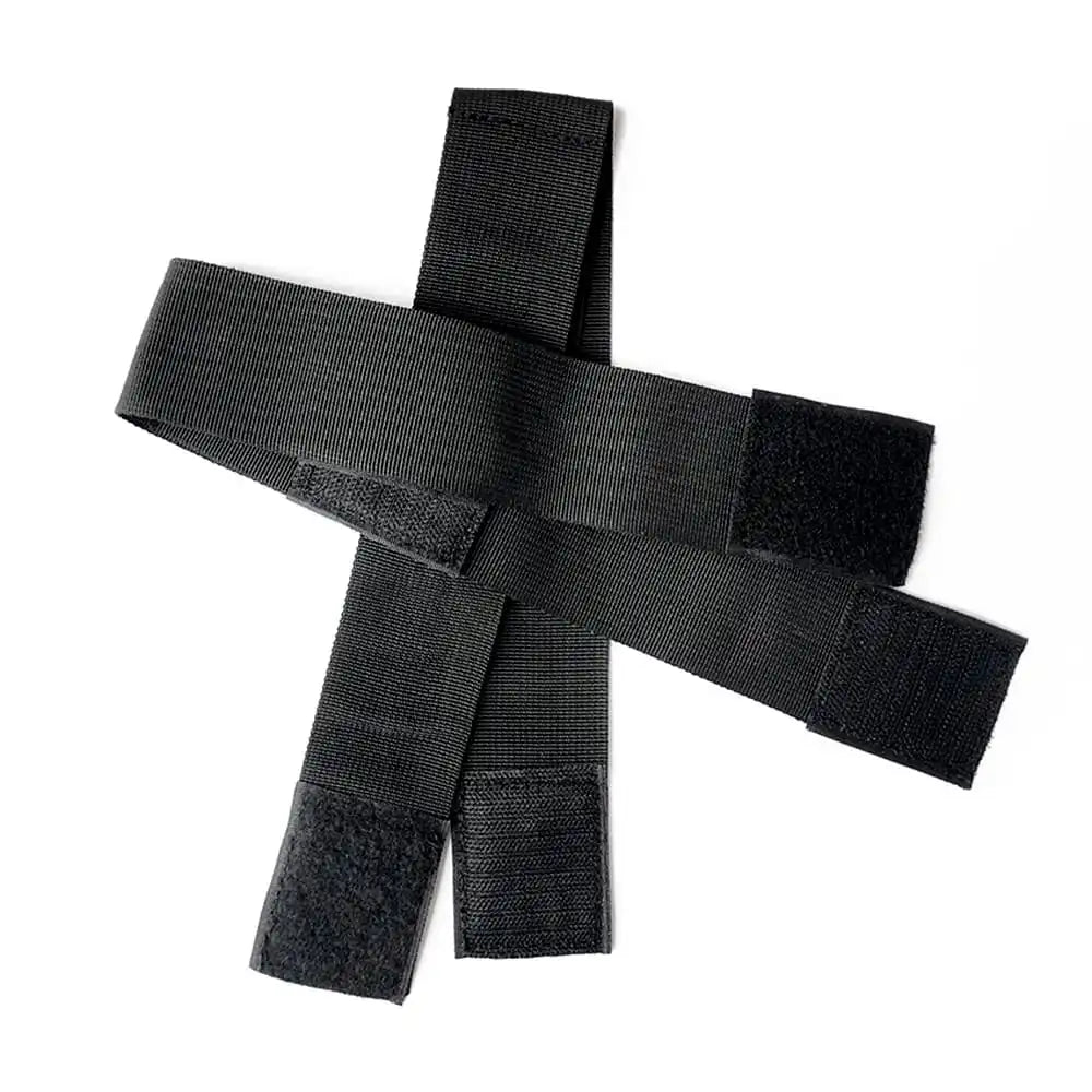Black wrist-to-thigh position restraint strap with adjustable wrist cuffs and leg positioning straps.